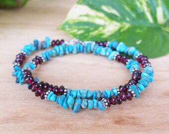 May include: A double-strand necklace with turquoise and garnet beads. The necklace is made of natural stones and is strung on silver wire.