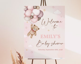 May include: A pink and brown baby shower welcome sign with a teddy bear holding balloons. The sign says "Welcome to Emily's Baby Shower" and includes the date "Saturday, September 28th, 2023".