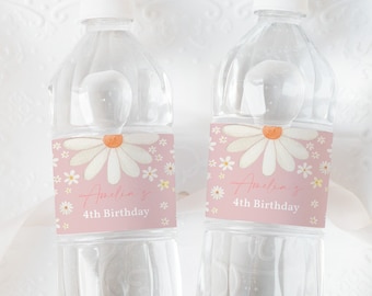 May include: Two clear plastic water bottles with pink and white daisy flower labels. The labels say "Amelia's 4th Birthday".