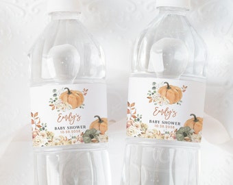 May include: Two clear plastic water bottles with labels featuring a watercolor pumpkin and floral design. The labels say "Emily's Baby Shower 10.28.2023".