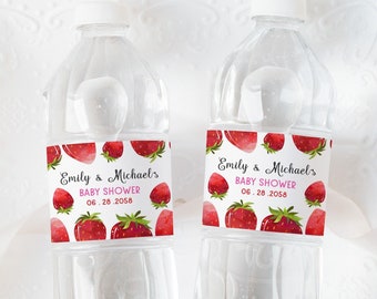 May include: Two clear plastic water bottles with labels featuring a watercolor strawberry design. The labels say "Emily & Michael's Baby Shower 06.28.2058".
