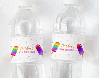 May include: Two clear plastic water bottles with colorful labels that say "Amelia's 6th Birthday" and feature a rainbow popsicle and a purple popsicle.