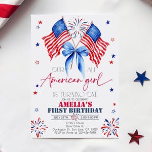 May include: A birthday invitation card with an American theme. It features two American flags, a blue bow, and star decorations. The text reads "Our American girl is turning one" and invites guests to Amelia's first birthday on July 28th.