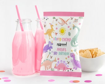 May include: Pink and white dinosaur-themed party favor bags with the text "stomp chomp roarrrr! Amelia's 3rd birthday".