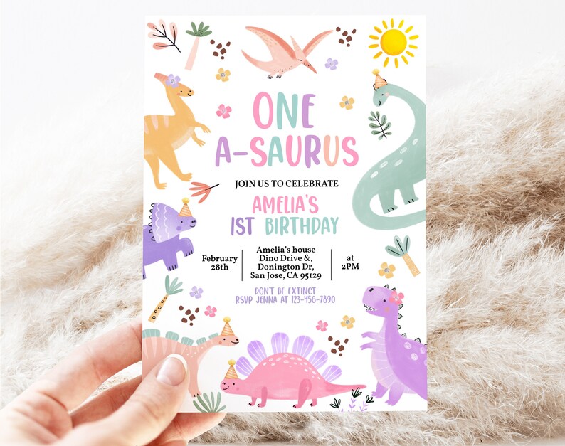 May include: A colorful dinosaur-themed birthday invitation with the text "One A-saurus Amelia's 1st Birthday" and details for the party, including the date, time, and location. The invitation features a variety of dinosaurs in pink, purple, green, and orange.