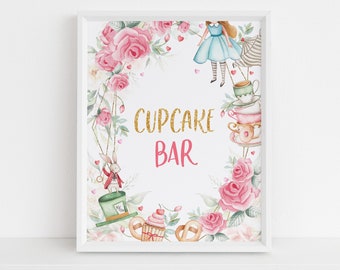 May include: A white framed printable sign with a pink and green floral border. The sign says "CUPCAKE BAR" in gold glitter letters with a pink heart on each side of the word "BAR". The sign features a watercolor illustration of Alice in Wonderland characters, including Alice, the Mad Hatter, and the White Rabbit.
