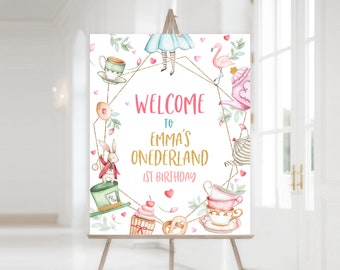 May include: Welcome to Emma's Wonderland 1st Birthday party sign with a whimsical Alice in Wonderland theme. The sign features a pink flamingo, a white rabbit, a teacup, a cupcake, and a pretzel.