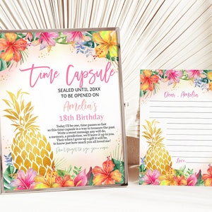 May include: A pink and gold time capsule sign with a pineapple graphic and tropical flowers. The sign says "Time Capsule" and "Sealed Until 20XX To Be Opened On Amelia's 18th Birthday". A matching card with a pineapple graphic and tropical flowers says "Dear Amelia" and "Love..."