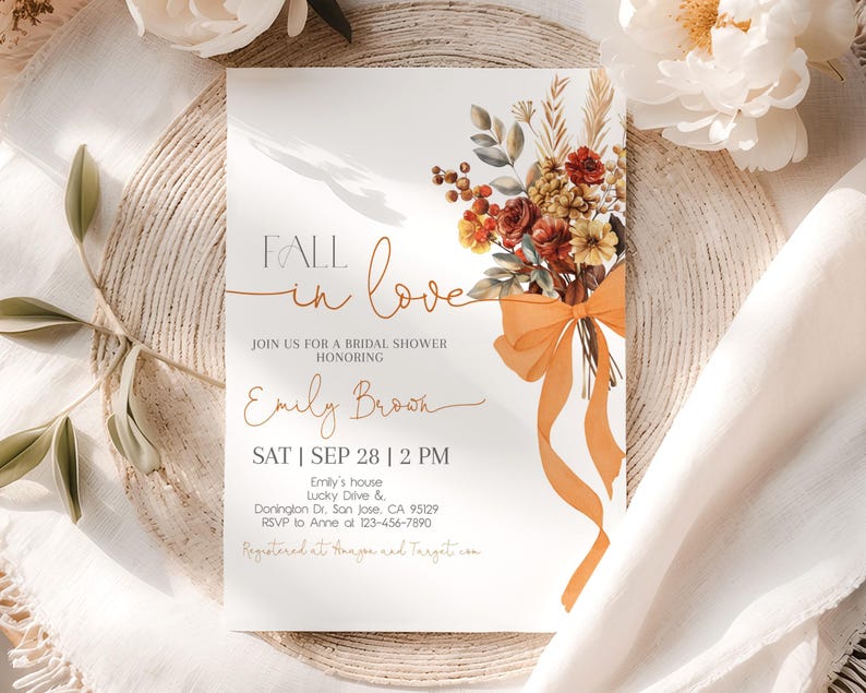 May include: Bridal shower invitation with the words "Fall in Love" in elegant script. The invitation features a floral bouquet with orange ribbon and text details including the name "Emily Brown" and event information.