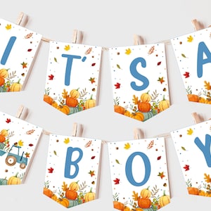 May include: It's a Boy banner with an autumn theme. The banner is white with blue letters and an autumn leaf pattern. The letters are in a banner shape with a pumpkin and leaf design at the bottom.