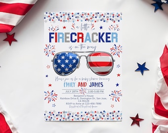 May include: A baby shower invitation with a patriotic theme. The invitation features sunglasses with American flag lenses and the text "A little FIRECRACKER is on the way." Additional text includes the date, time, and location.