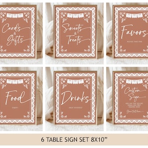 May include: A set of six rectangular table signs with a terracotta background and white decorative borders. Each sign features white text including Cards & Gifts, Sweets & Treats, Favors, Food, Drinks, and Custom Sign, with floral accents and bunting.