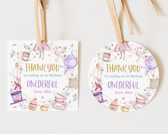 May include: Two thank you tags with a whimsical Alice in Wonderland theme. The tags feature a purple teapot, a pink flamingo, a white rabbit, and a Mad Hatter's hat. The text on the tags reads "Thank you for making my 1st Birthday ONEDERFUL Love, Alice".