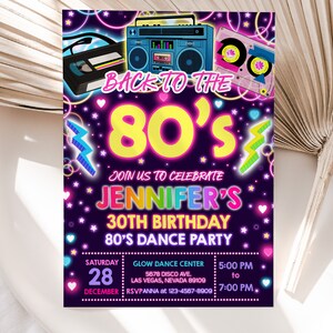 Pode incluir: Um convite rosa e azul neon para uma festa de anivers&aacute;rio de 30 anos com o texto "De volta aos anos 80" e "30&ordm; anivers&aacute;rio de Jennifer, festa de dan&ccedil;a dos anos 80". O convite apresenta um toca-fitas retro, fitas cassete e raios.