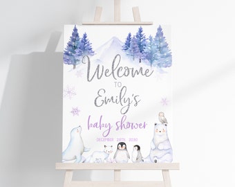 May include: Welcome to Emily's baby shower sign with a purple and silver glitter font. The sign features a snowy mountain scene with a polar bear, penguin, seal, and owl. The date of the shower is December 28th, 2030.