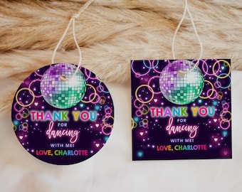 May include: Round and rectangular thank you tags with a disco ball design. The tags are purple with neon pink, yellow, blue, and green accents. The text on the tags reads "Thank you for dancing with me! Love, Charlotte".