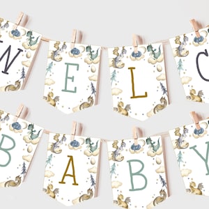 May include: A banner that spells "WELCOME BABY" with individual pennants. Each pennant is white with a watercolor illustration of dragons, clouds, and trees. The letters are in various colors, including navy, teal, and gold, and are attached to a string with wooden clothespins.