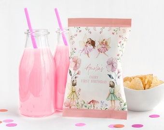 May include: Pink and white fairy-themed party favor bags with the text "Amelia's Fairy First Birthday".