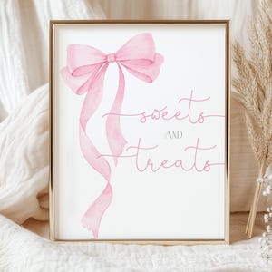 May include: A printable sign with a pink watercolor bow and the text "sweets and treats" in pink script font. This sign is perfect for a party or event.