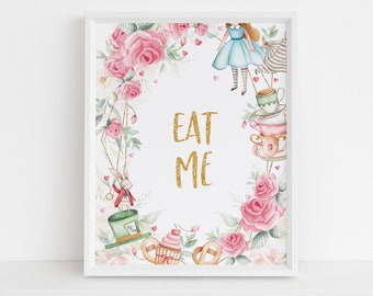 May include: A white framed print with a watercolor illustration of a whimsical tea party scene. The print features pink roses, a white rabbit, a teacup stack, a cupcake, and a girl in a blue dress. The text "EAT ME" is written in gold glitter.