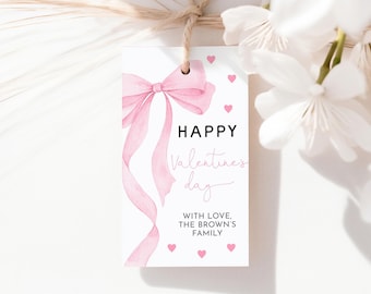 May include: A white gift tag with a pink watercolor bow and ribbons. The tag reads "HAPPY Valentines day" with pink hearts scattered around the edges. The text "WITH LOVE, THE BROWN'S FAMILY" is also included.
