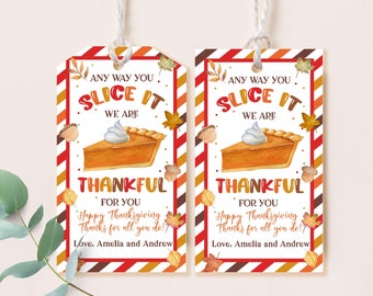 May include: Two printable gift tags with a Thanksgiving theme. The tags feature a slice of pumpkin pie with whipped cream, fall leaves, and the text "Any way you slice it, we are thankful for you. Happy Thanksgiving. Thanks for all you do! Love, Amelia and Andrew."