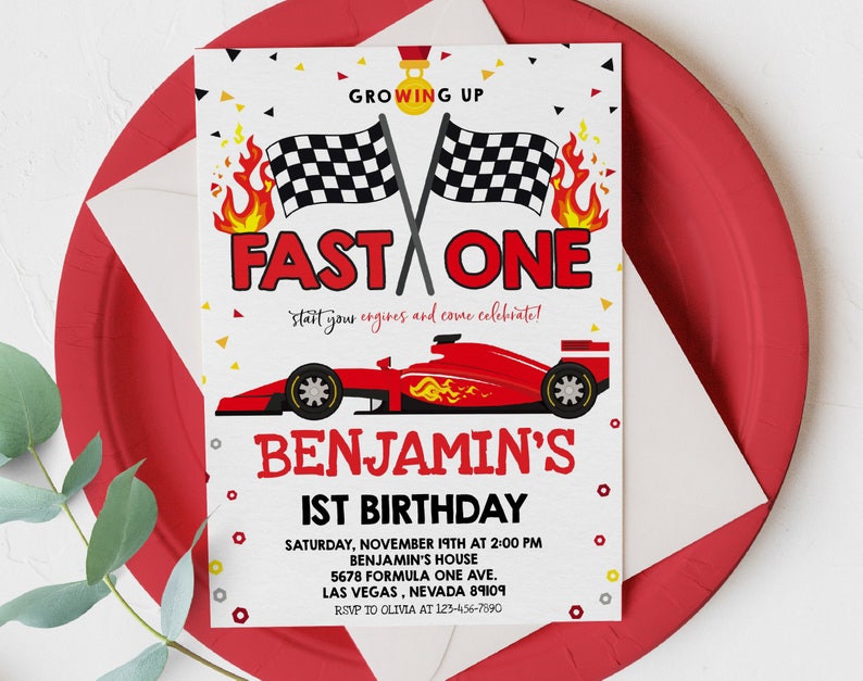 May include: A red, white and black birthday invitation with a red racing car and chequered flags. The text reads "Growing Up Fast One, start your engines and come celebrate! Benjamin's 1st Birthday. Saturday, November 19th at 2:00 PM, Benjamin's House, 5678 Formula One Ave, Las Vegas, Nevada 89109, RSVP to Olivia at 123-456-7890."