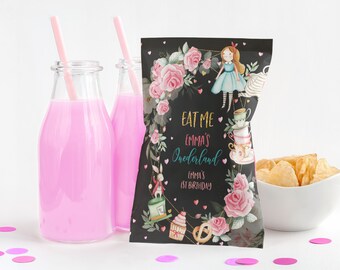 May include: A black and white party favour bag with a floral design and the text "Eat Me Emma's Wonderland Emma's 1st Birthday".