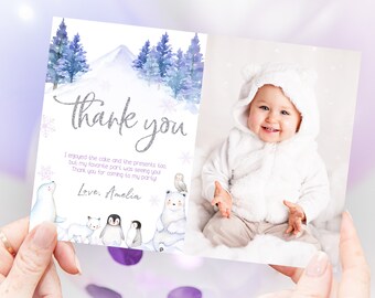 May include: A folded thank you card with a winter theme. The left side features a watercolor illustration of a snowy landscape with trees and the words "Thank You." The right side displays a photo of a baby in a white bear costume.