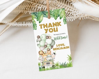 May include: Thank you card with a jungle theme. It features a green jeep with animals on top, balloons, and green leaves. The text says "Thank You" in gold letters, "We hope you had a Wild time!" and "Love, Benjamin".