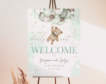 May include: A welcome sign for a baby shower with a green and brown color scheme. The sign features a teddy bear holding onto balloons and the text "We can barely wait. Welcome to Benjamin and Emily's Baby Shower 08.28.2058."
