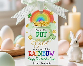 May include: A St. Patrick's Day gift tag with a green ribbon. The tag features a pot of gold at the end of a rainbow, with the text "You are the POT of Gold at the end of the RAINBOW. Happy St. Patrick's Day! From, Benjamin."