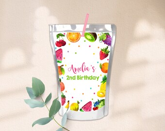 May include: A white juice pouch with a colorful fruit design. The pouch has a pink straw and says "Amelia's 2nd Birthday" in pink lettering.