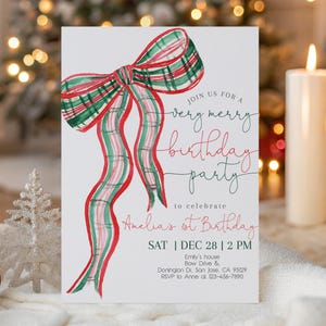 May include: A white invitation card featuring a watercolour illustration of a red, green, and white plaid bow. The text reads "Join us for a very merry birthday party" and "Amelia's 1st Birthday". Includes date, time, and location details.