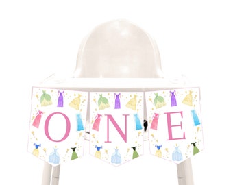 May include: A pink and white high chair banner with the word "ONE" in pink letters. The banner is decorated with images of princess dresses and wands.