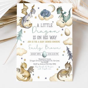 May include: A baby shower invitation with a watercolor illustration of a blue dragon on a cloud. The text reads "A Little Dragon Is On His Way" and includes the date, time, and location of the event.