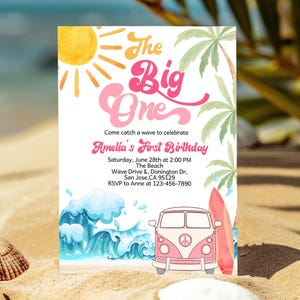 May include: A colorful invitation for a first birthday party with a beach theme. The invitation features a sun, waves, a pink and white vintage van, and a surfboard. The text on the invitation reads "The Big One" and "Come catch a wave to celebrate Amelia's First Birthday".