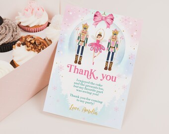 May include: A pink and blue thank you card with a ballerina and two nutcracker soldiers. The card has a snowflake design and the text "Thank you. I enjoyed the cake and the presents too, but my favorite part was seeing you! Thank you for coming to my party! Love. Amelia."