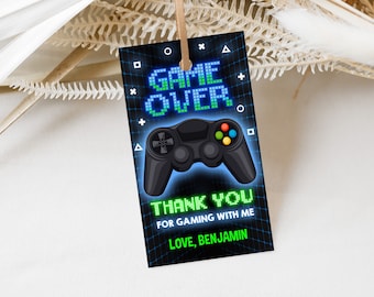 May include: A black and green thank you tag with a pixelated game controller and the text "Game Over" in green and blue. The text "Thank You for gaming with me Love, Benjamin" is also on the tag.