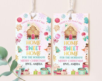 May include: Two pink and white Christmas gift tags with a gingerbread house, snowman, and candy canes. The text reads "There's no place like home sweet home for the holidays! Merry Christmas Love, Amelia".