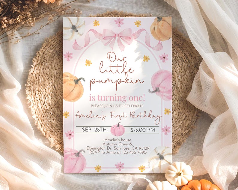 May include: A pink and white invitation card with watercolor pumpkins and floral accents. The text reads "Our little pumpkin is turning one!" and includes details for Amelia's first birthday, such as the date, time, and location.