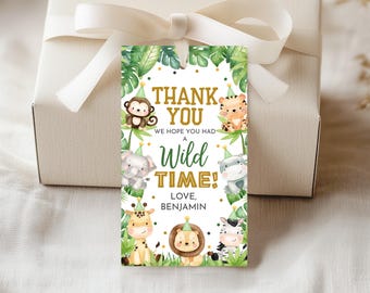 May include: A jungle-themed gift tag with cartoon animals and the text "THANK YOU, WE HOPE YOU HAD A WILD TIME!" in gold and green. The tag features a monkey, tiger, elephant, hippo, giraffe, lion, and zebra. It is attached to a white gift box with a white ribbon.