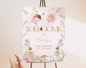 May include: A baby shower welcome sign featuring watercolor fairies, flowers, and the text "WELCOME to Emily's BABY SHOWER 10.28.2058". The sign is displayed on a wooden easel, with a soft pink and floral design.