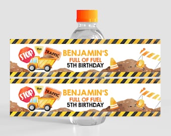 May include: Two printable water bottle labels with a construction theme. The labels feature a yellow construction truck, a stop sign, a traffic sign, and the text "Benjamin's Full of Fuel 5th Birthday".