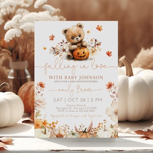 May include: A baby shower invitation featuring a teddy bear and pumpkin design. The text reads "falling in love with Baby Johnson" and includes event details. The design incorporates autumnal elements like leaves and pumpkins.