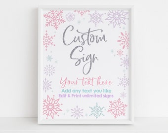 May include: A white frame with a white background and a silver glitter design that says "Custom Sign" with the text "Your text here Add any text you like Edit & Print unlimited signs" below. The background is decorated with pink, purple, and blue snowflakes.