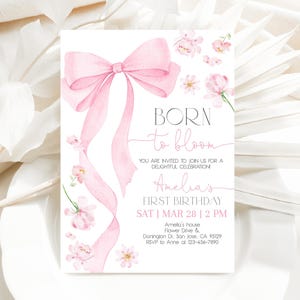 Może przedstawiać: Różowe zaproszenie akwarelowe z dużą różową kokardą i kwiatowymi akcentami. Tekst brzmi "Born to Bloom Amelia's First Birthday Sat | Mar 28 | 2 PM Amelia's house Flower Drive & Donington Dr. San Jose, CA 95129 RSVP to Anne at 123-456-7890"