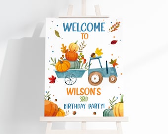 May include: A birthday party sign on an easel, illustrated in watercolour. The sign says "WELCOME TO WILSON'S 3RD BIRTHDAY PARTY!" and shows a blue tractor with a cart of pumpkins and autumn leaves.