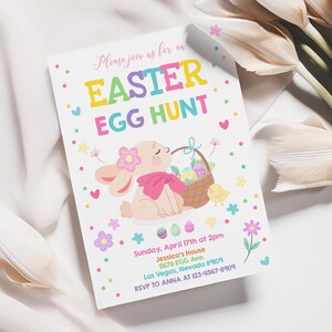 May include: An invitation to an Easter egg hunt with a pink bunny holding a basket of colorful eggs. The invitation includes the date, time, location, and contact information for RSVP.