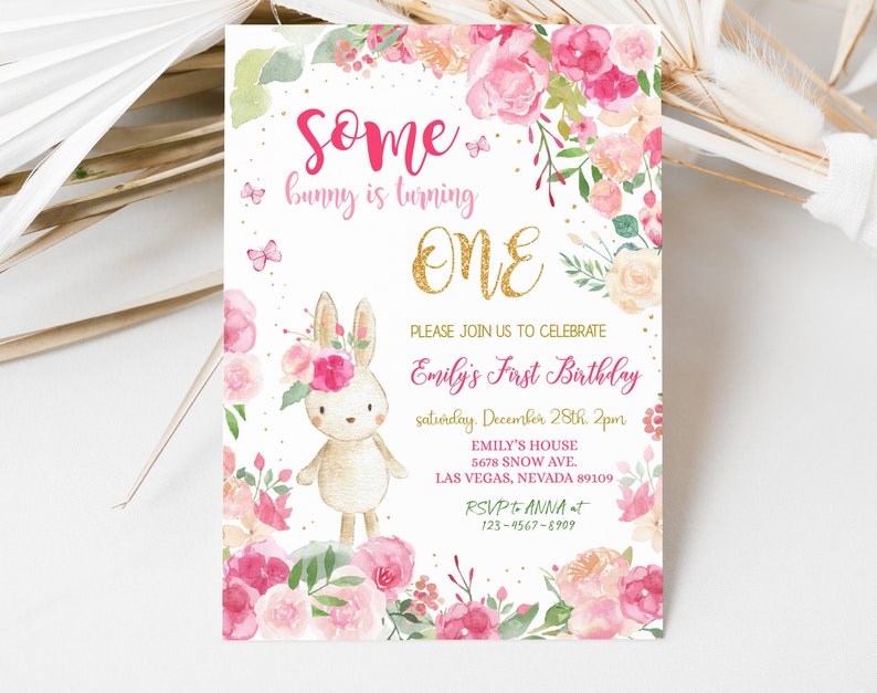 May include: A pink and gold first birthday invitation with a cute bunny rabbit wearing a flower crown. The invitation says "Some bunny is turning ONE" and includes details for the party, including the date, time, and location.